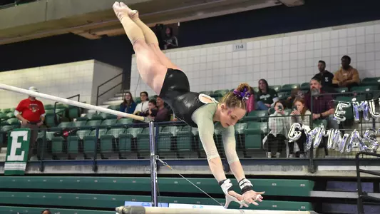Kyrie Lowe jumps to low bar during Kent State bars routine