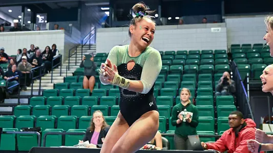 Molly Parris smiles after vault performance against Kent State