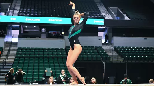 Mayleigh Vanderbeek smiles during beam exhibition against BGSU