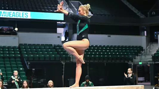 Mayleigh Vanderbeek does one foot skill during beam exhibition against BGSU