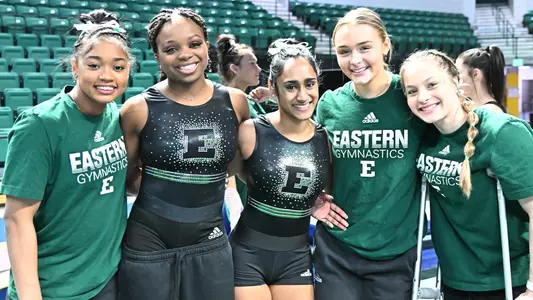 Five Eagle Gymnasts smile for camera before BGSU meet during vault warmups