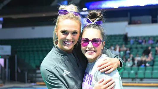 Sophia Rios and Mayleigh Vanderbeek smiling for camera during Kent State meet