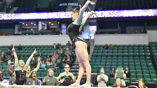 Ella Chemotti smiles during beam routine against Kent State