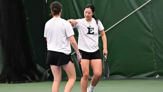 Teammates W. Zhang and D. Shved celebrate a point