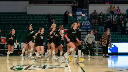 Volleyball storms the court after a reverse sweep over NIU, Oct. 17, 2024