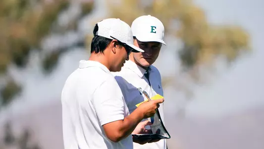 James Baxter and Assistant Coach Ryan Yip look over course yardage