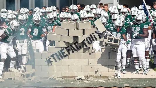 EMU Football Takes Down the Wall