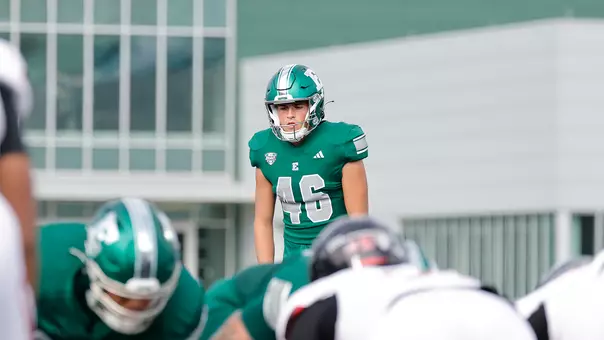 Rudy Kessinger lines up a kick for an extra point in the game against Northern Illinois, Oct. 11, in Ypsilanti