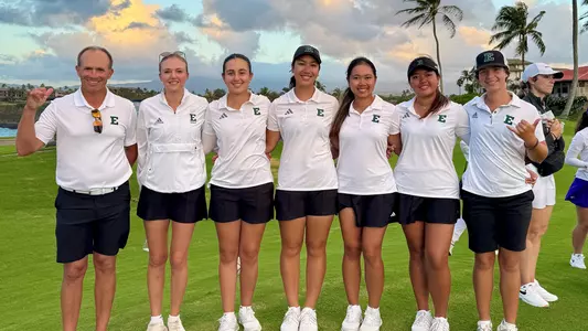 Josh Brewer and five of his players pose for a picture in Hawai'i ahead of the 2025 Rainbow Wahine Invitational.