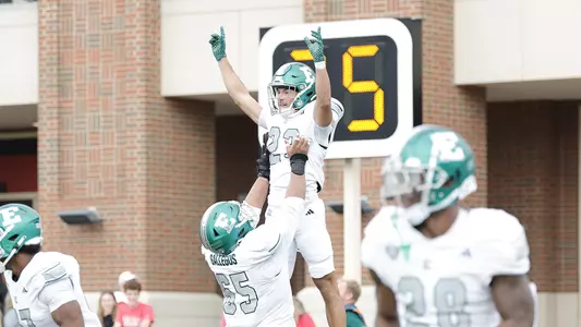 Harold Mack Jr. is lifted in the air by Nicholas Gallegos to celebrate his career reception that went for a 51-yard touchdown at Miami