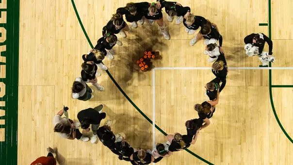 Volleyball team huddle while playing against Buffalo Oct. 24, 2025