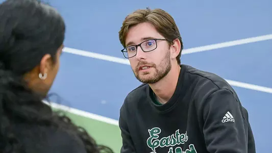 Head Coach Ryan Kucera talks with Pehal Kharadkar during her fall match at the Block E Invitational