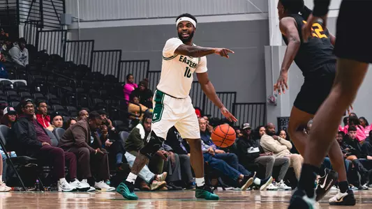 Jon Sanders II dribbling a basketball with his left hand while pointing with his right hand against Tuskegee, Oct. 30, 2025