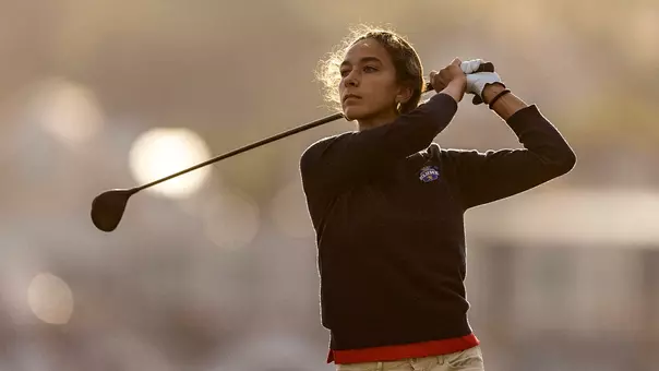 Laura Gorgees Baeta, who signed with the women's golf team, poses after taking a shot at a tournament in Spain
