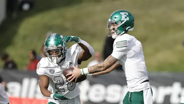 Dontae McMillan takes a handoff from Noah Kim in the game at Ball State