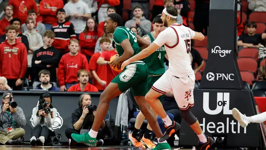John Shanu II holding a basketball while being guarded at Louisville, Nov. 24, 2025