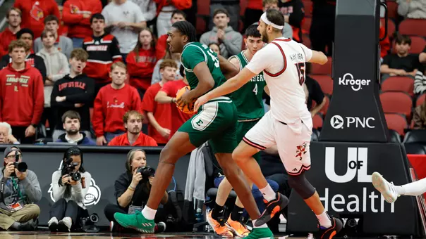 John Shanu II holding a basketball while being guarded at Louisville, Nov. 24, 2025