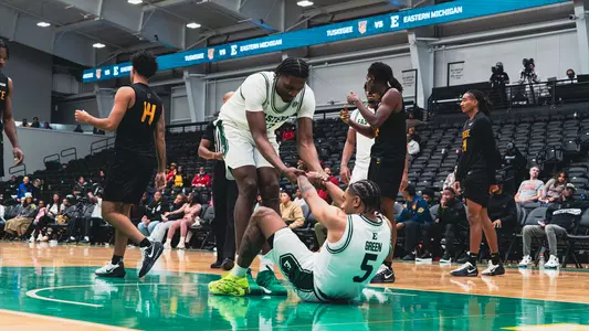 John Shanu II helping Braelon Green stand up