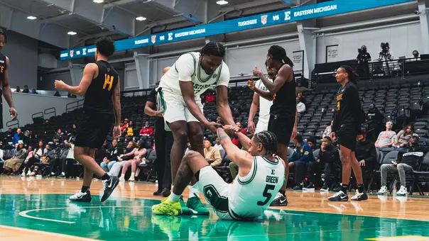 John Shanu II helping Braelon Green stand up