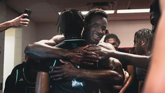Godslove Nwabude hugging Carlos Hart in the locker room after beating Cincinnati, Nov. 26, 2025