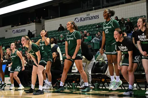 The Eastern Michigan bench celebrates a play against Defiance, Dec. 5, 2025
