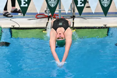 Swimmer dives in against Oakland, Nov. 21, 2024