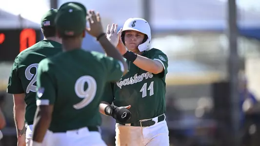 Bruce Jellison celebrates scoring a run against Pitt, Feb. 15, 2024