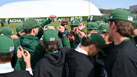 Baseball team huddle prior to facing Michigan, April 1, 2025