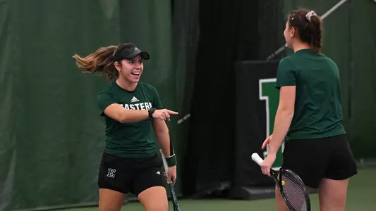 Regina Mendoz Carreno reacts after winning a point with teammate Iva Daneva in doubles against Cleveland State