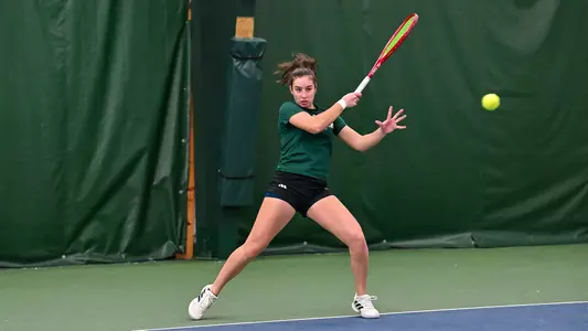 Matilde Parreira returns a shot against Cleveland State in the season-opening match