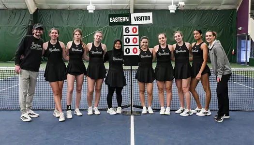 The tennis team poses with a 6-0 sign after defeating Oakland, Jan. 31, to move to a program-record-tying 6-0