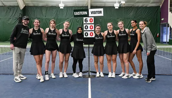The tennis team poses with a 6-0 sign after defeating Oakland, Jan. 31, to move to a program-record-tying 6-0