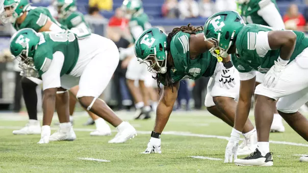 The defensive line prepares to rush the backfield at Akron