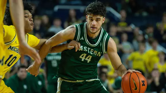 Aviv Aronov drives the ball into the paint at Michigan, October 11, 2026