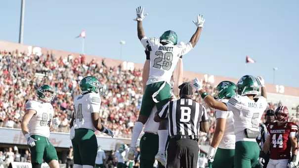 Braydon Bennett is hoisted into the air after scoring a touchdown at UMass