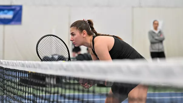 Iva Daneva looks over the net while awaiting a serve in doubles action against Oakland