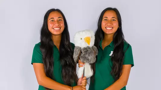 Janae Leovao (L) and Jasmine Leovao (R) pose with an eagle club head cover on media day