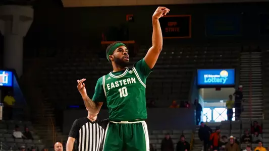 Jon Sanders II watching a basket swish through a basketball hoop with his left arm raised at Appalachian State, Feb. 7, 2026
