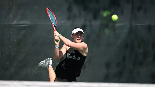 Sabrina Tolstova returns a shot down the line against Stetson