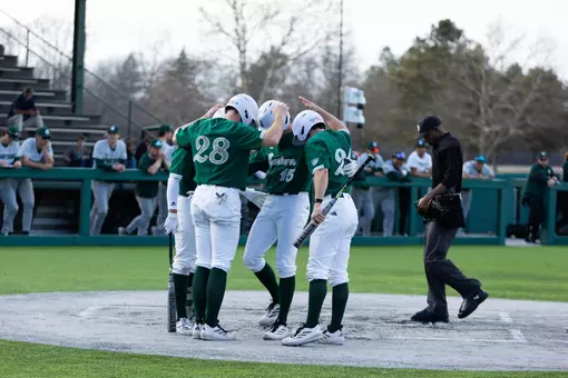 2026 EMU baseball team celebrates at home plate after hitting a home run against Michigan State, March 10, 2026