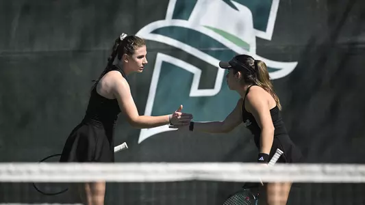 Iva Daneva and Regina Mendez Carreno smacks hands after a point during doubles play at Stetson