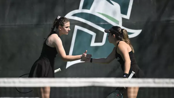 Iva Daneva and Regina Mendez Carreno smacks hands after a point during doubles play at Stetson