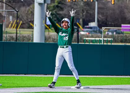 Devan Zirwas celebrates hitting a triple against Akron, March 21, 2026