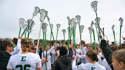 The lacrosse team puts their sticks in the air ahead of taking the field against Kent State