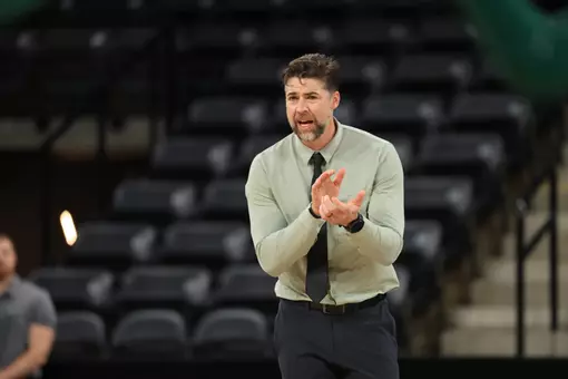 Head Volleyball Coach Kevin Foeman coaches on the sideline against Oakland, Sept. 19, 2025