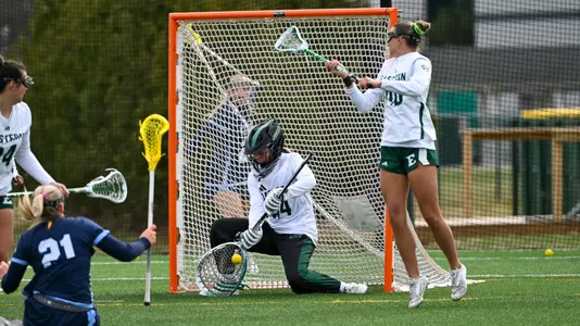 Maddy Porter goes low to make a save on a Kent State shot attempt