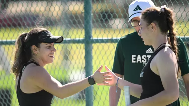 Regina Mendez Carreno (left) and Iva Daneva slaps hands after a doubles point at Stetson