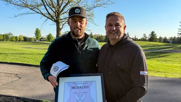 Charlie Box (left) poses with his medalist plaque near the 18th green after finishing in a tie for first place at The Muirfield Shootout, April 20, in Dublin, Ohio