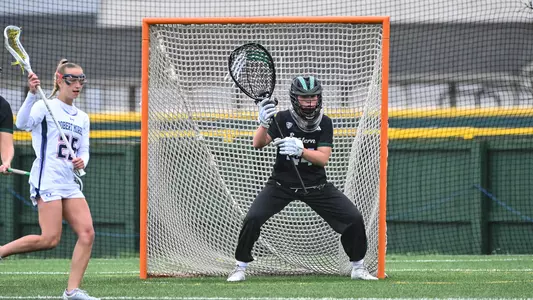 Maddy Porter stares down an oncoming attacker from Robert Morris as she defends her cage at Scicluna Field