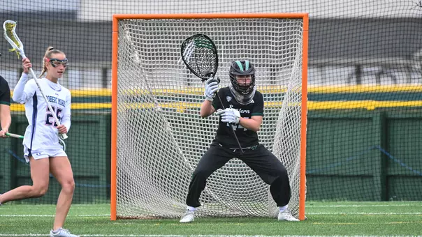 Maddy Porter stares down an oncoming attacker from Robert Morris as she defends her cage at Scicluna Field